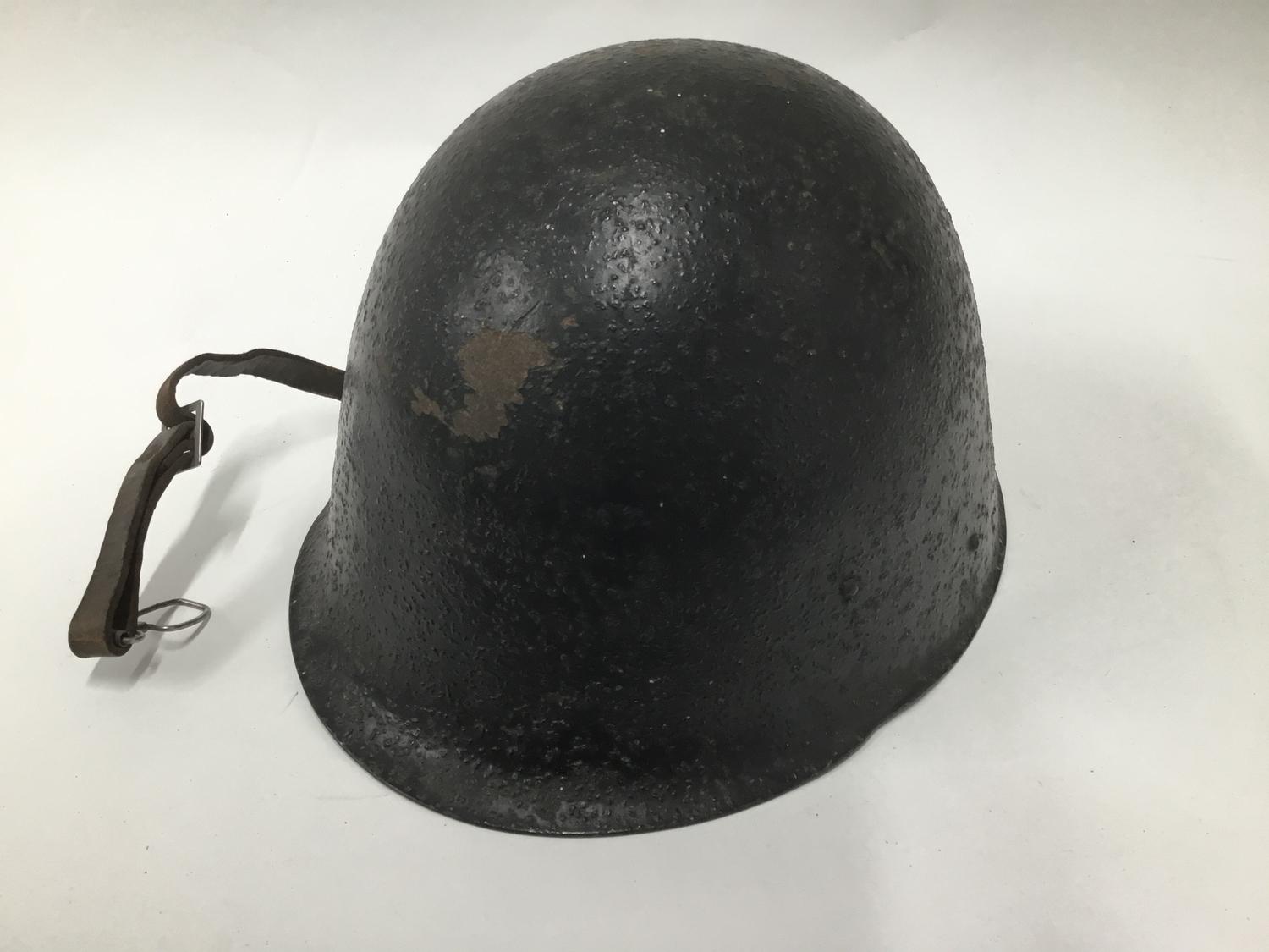 A Polish Military helmet with stencil to the 'Ludikow 42/37' with leather chin strap.