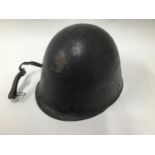 A Polish Military helmet with stencil to the 'Ludikow 42/37' with leather chin strap.