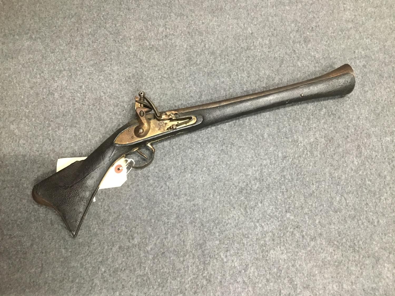 A small decorative Continental Blunderbuss Flintlock pistol with cast barrel and shagreen stock.