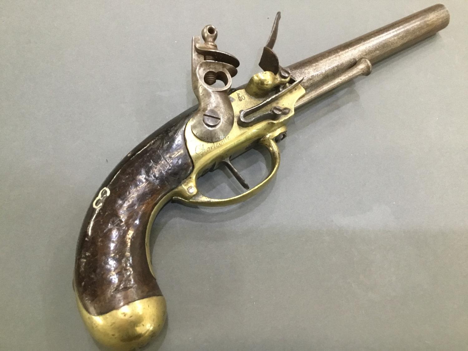 An early 19th Century French Flinlock pistol engraved 'Charleville' stamped 'F80'
