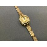 9ct. gold ladies Swiss made wristwatch with gold rolled bracelet