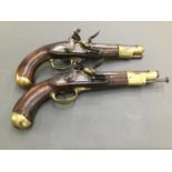 A matched pair of early 19th Century Flintlock pistols, engraved 'Manufe Nalco de Charleville'