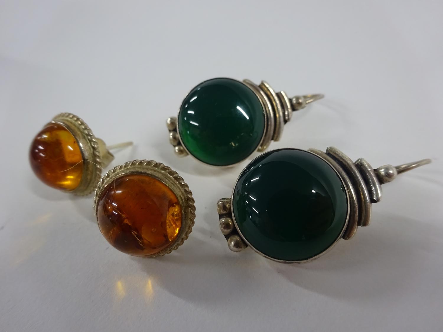 2 pairs of silver earrings (one green pair and other amber)