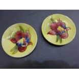 Two Moorcroft pottery trinket dishes with iris decoration, on yellow ground