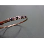 9ct bangle with C.Z stones and dark Sapphire stones to the top, hoop and pin clasp, weight 5.8g
