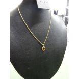 9ct gold fine necklace with 9ct gold pendant having a oval dark red stone, total weight 4.5g
