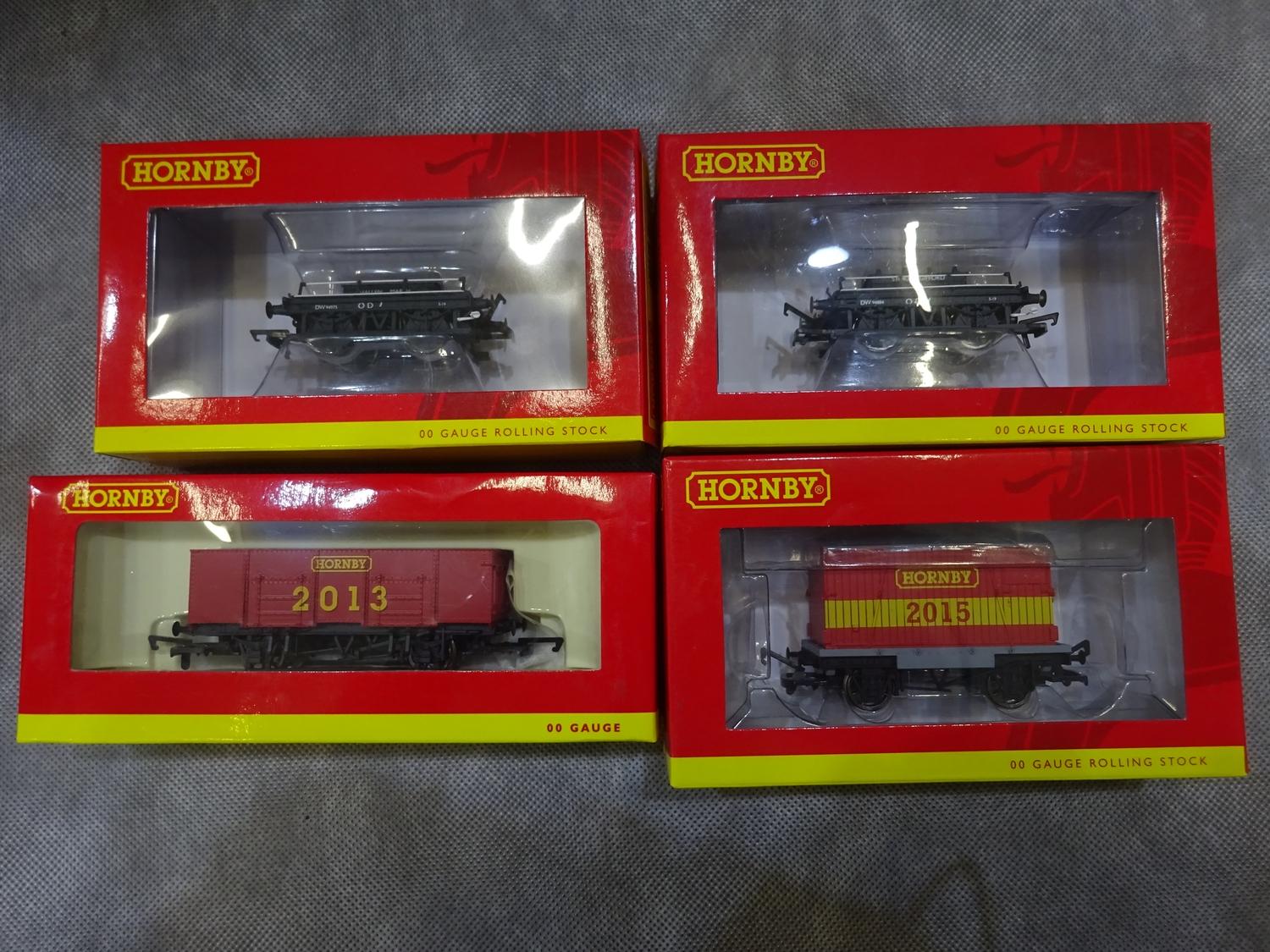 Four Hornby boxed carriages and trucks