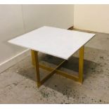 Contemporary gold coffee table with square marble top.
