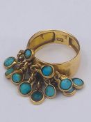 An 18ct yellow gold turquoise set contemporary dress ring comprising a tapered court shaped hollow