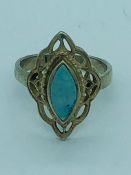 A silver ring with central opal panel