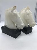 A pair of Marble Horse Heads on plinths