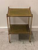 Two tier brass leather topped tea table on brass castors (AF)