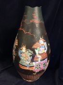 A large Chinese Famille rose vase covered in a black over material with cut outs.AF