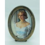 A small oval silver picture frame