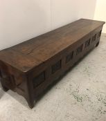 An Oak Coffer with carved panels to front. 184cm W x 45cm H x 46cm D