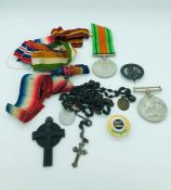 A selection of British war medal ribbons, along with two British WWII Defence medals.