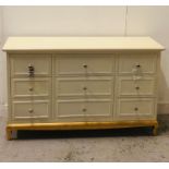 A Pair of multiple drawer chest of drawers with chrome handles on a painted gold base (One AF with a