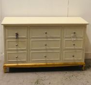 A Pair of multiple drawer chest of drawers with chrome handles on a painted gold base (One AF with a