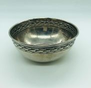 A small decorative white metal bowl