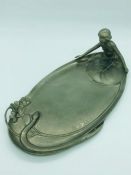 An Art Nouveau pewter tray with Eve and the snake theme.