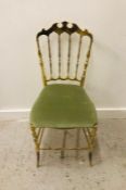 A brass dressing chair with sage green seat