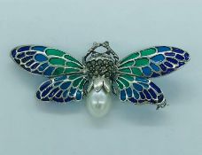 A silver and plique a jour butterfly brooch with fresh water pearl body