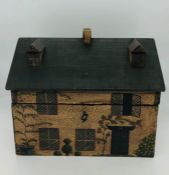 An unusual mahogany tea caddy in the form of a house with twin lidded compartments