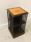 Leather topped rotating library bookcase on castors