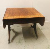 A Regency Sofa Table with stringing and two frieze drawers and splayed feet with brass capping