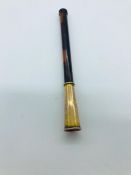 A cigarette holder with a 9ct gold mount.