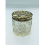 A silver topped glass dressing table jar