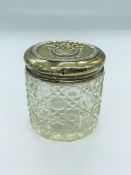 A silver topped glass dressing table jar