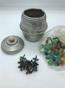 A Metal barrel containing vintage marbles and jacks