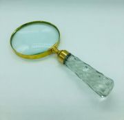 A large brass hand held magnifying glass