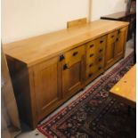A Large Oak side board with a selection of cupboards, drawers etc 275cm Long x 72cm Deep by 86cm