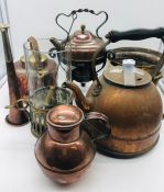 A selection of cooper and brass items to include 4 teapots, jugs with lids, a platter, a candle