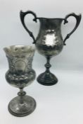 Two highly decorative pewter goblets, one with handles.