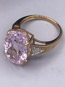 A Pink Kunzite & Diamond ring 10 carat Oval Brilliant cut Kunzite, the shoulders set with S.I.