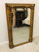 A Heavy gilt ornate mirror 140cm x 92cm (AF)