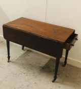 Drop leaf table on turned legs with castors, one drawer at one end