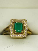 An Emerald and yellow gold ring