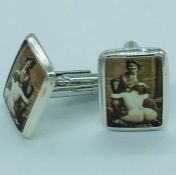 A pair of silver and enamel cufflinks with erotic image