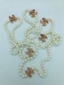 A long row of cultured pearls with rose gold style designer spacers