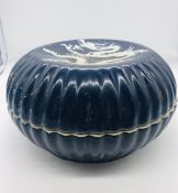 A large dark blue Chinese scalloped lidded bowl with dragon motif.