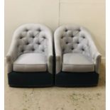 Two Charcoal and Light grey upholstered swivel style chairs.