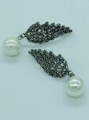 A pair of silver marcasite and cultured pearl drop earrings of winged form