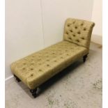 A sage green and cream upholstered day bed with brass studded detail