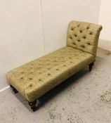 A sage green and cream upholstered day bed with brass studded detail