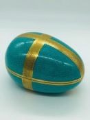 A turquoise and gold coal port egg shaped dish