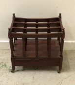 A mahogany magazine rack with drawer